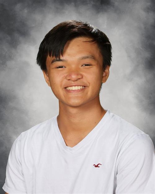 Teenage boy smiling wearing a white shirt